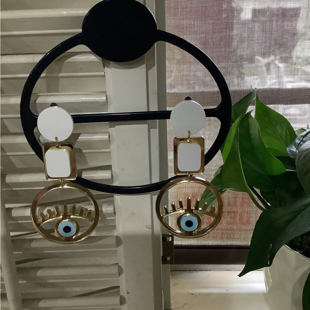 Round evil eye clip on earrings.